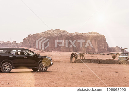 Planet Mars like landscape - Photo of Wadi Rum desert in Jordan with red pink sky above, this location was used as set for many science fiction movies Planet Mars like landscape - Photo of Wadi Rum desert in Jordan with red pink sky above, this location was used as set for many science fiction movies 106068990