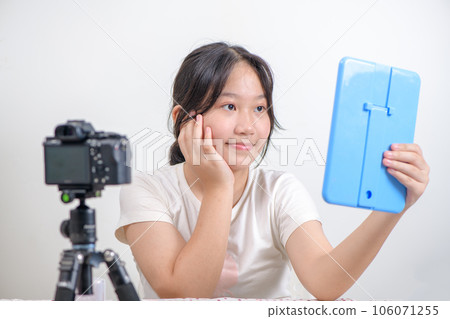 Beauty girl blogger concept, Asian girl llook in the mirror in live streaming on white 106071255