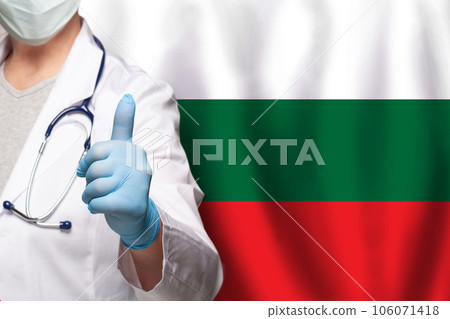 Bulgarian doctor's hand showing thumb up positive gesture on flag of Bugary background Bulgarian doctor's hand showing thumb up positive gesture on flag of Bugary background 106071418