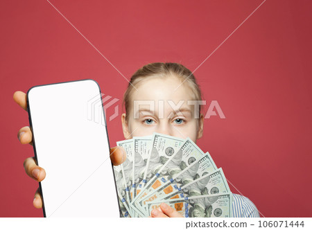 Young female model showing smartphone with blank empty white screen display and money cash  106071444