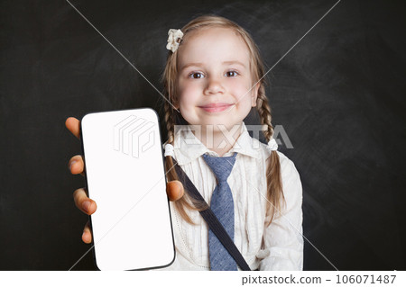 Cute young girl school student holding smartphone with blank empty white screen display Cute young girl school student holding smartphone with blank empty white screen display 106071487