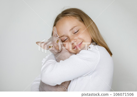 Cute sweet child girl embracing cat pet on white background Cute sweet child girl embracing cat pet on white background 106071506