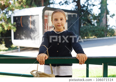 Cheerful young girl outdoor portrait. Cute child posing outdoors Cheerful young girl outdoor portrait. Cute child posing outdoors 106071514