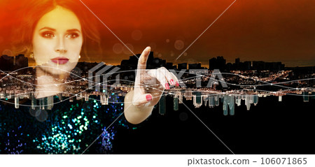 Female hand against beautiful night sity with red sky background Female hand against beautiful night sity with red sky background 106071865