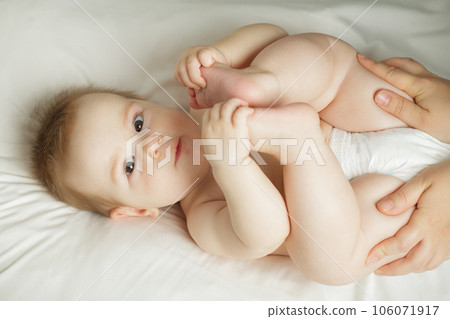 Cute little baby looking at camera, indoor portrait. Beautiful small child, 6 months old Cute little baby looking at camera, indoor portrait. Beautiful small child, 6 months old 106071917