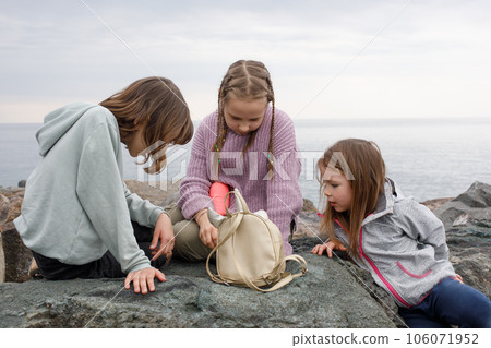 Little children playing together outdoors 106071952