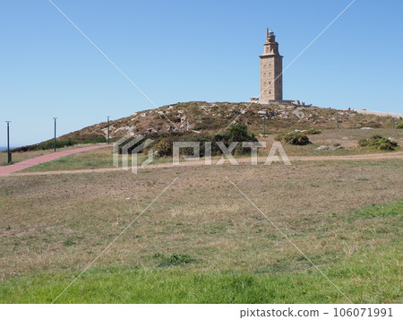 Grassy hill with tower of Hercules in A Coruna city at Galicia, Spain 106071991