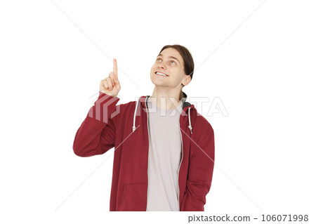 Happy young man pointing up at copy space isolated on white background Happy young man pointing up at copy space isolated on white background 106071998