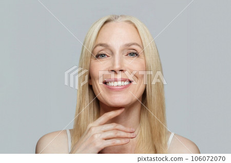 Smiling mature woman with blonde hair portrait Smiling mature woman with blonde hair portrait 106072070