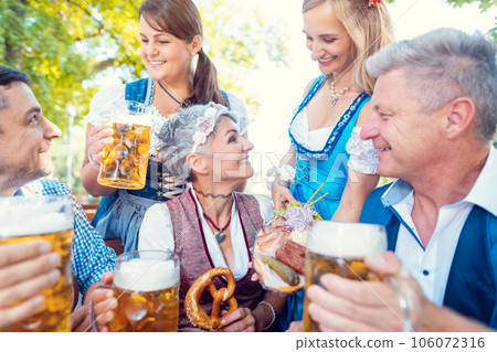 Group of friends in Bavarian beergarden 106072316