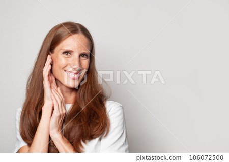 Portrait of happy smiling woman looking at camera on white background 106072500