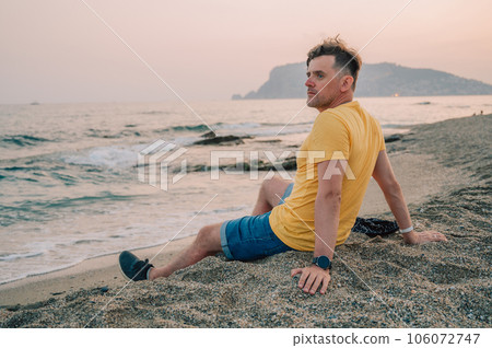 Man sits on the beach and looks at the sea in Alanya city 106072747