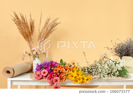 Bouquet of fresh flowers on tables at florist workplace copy space for promotion advertisement area. 106073577