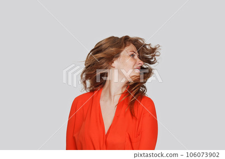 Pretty woman with red wavy hair in motion Pretty woman with red wavy hair in motion 106073902