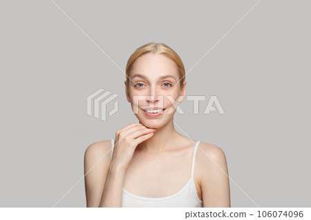 Gorgeous woman smiling isolated on grey background. Beauty, cosmetics, skincare, glamour Gorgeous woman smiling isolated on grey background. Beauty, cosmetics, skincare, glamour 106074096
