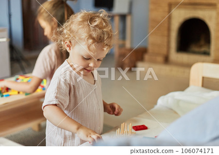 Colorful sorting shapes. Preschool learning games. Colorful sorting shapes. Creative art exploration. Little girls playing with educational toys at home interior. Colorful sorting shapes. Preschool learning games. Colorful sorting shapes. Creative art exploration. Little girls playing with educational toys at home interior. 106074171