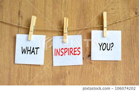 What inspires you symbol. Concept words What inspires you on beautiful white paper on clothespin. Beautiful wooden background. Business motivational what inspires you concept. Copy space. 106074202