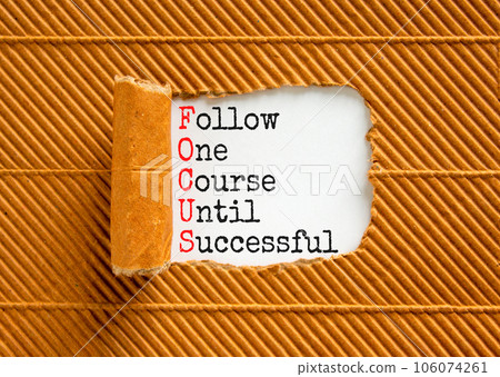 FOCUS follow one course until successful symbol. Concept words FOCUS follow one course until successful on white paper. Brown background. Business FOCUS follow one course until successful concept. 106074261