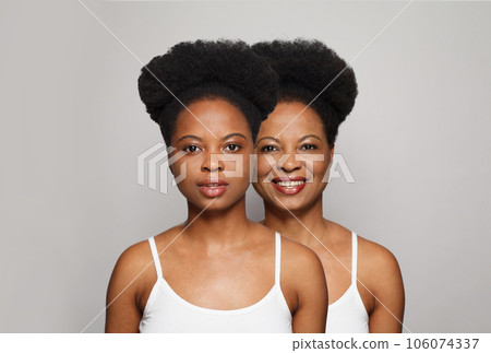 Happy women, mother and daughter. Young female face with fresh clear skin and happy senior lady  106074337