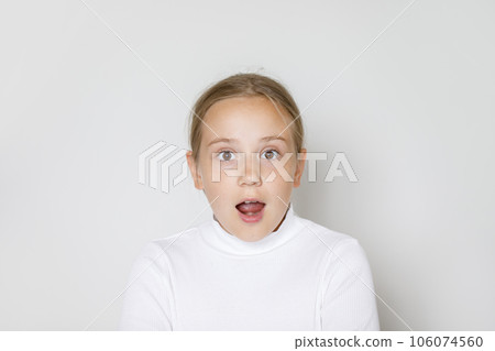 Shocked excited child girl with opened mouth on white color background portrait. Shocked excited child girl with opened mouth on white color background portrait. 106074560