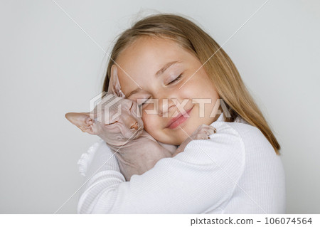 Cute child girl embracing cat pet, portrait Cute child girl embracing cat pet, portrait 106074564