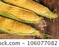 Corn on a brown wooden background 106077082