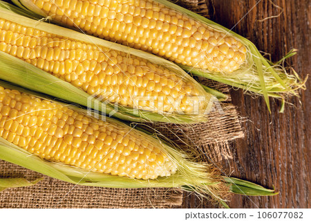 Corn on a brown wooden background 106077082