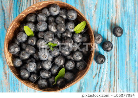 Blueberries in a wooden bowl Blueberries in a wooden bowl 106077084
