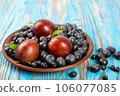 Fresh blueberries and plums in a plate 106077085