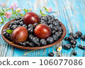 Fresh blueberries and plums in a brown plate 106077086