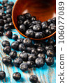 Scattered blueberries on a blue background 106077089