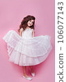 Full size body length little cute kid girl 5-6 years old wears pink dress dancing on pink background 106077143