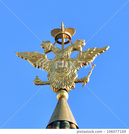 Double-headed eagle - coat of arms of the Russian Federation on the spire of Resurrection Gate in the Kremlin in Moscow, Russia 106077189