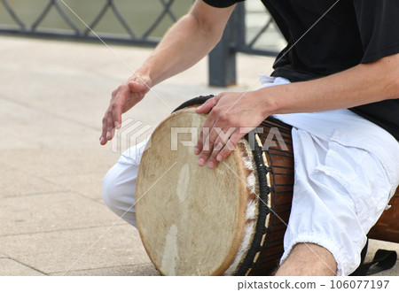 A man plays the djembe drum on a street in Moscow, Russia A man plays the djembe drum on a street in Moscow, Russia 106077197