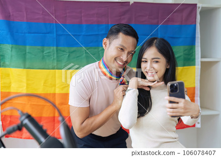 LGBTQIA friends taking selfies together with the Pride flag. LGBTQIA concept LGBTQIA friends taking selfies together with the Pride flag. LGBTQIA concept 106078407