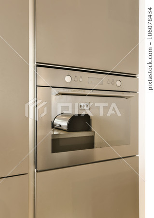 an oven with the door open showing it's handle and knobs that are not in use or working 106078434