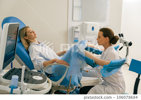 Young woman on appointment with her gynecologist during regular visit to women's consultation 106078684