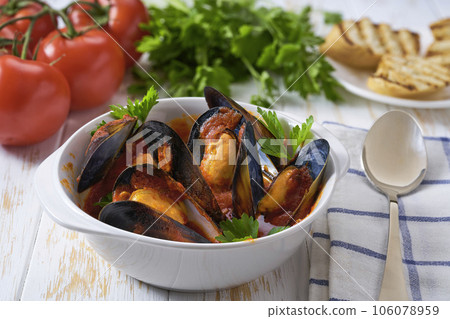 Tomato soup with mussels on a white table, selective focus. 106078959