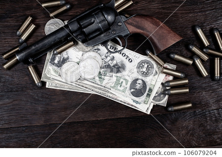Old west Colt Peacemaker and US banknotes and silver certificates with silver dollar coins and .45 caliber revolver ammunitions Old west Colt Peacemaker and US banknotes and silver certificates with silver dollar coins and .45 caliber revolver ammunitions 106079204