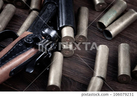 Vintage retro double-barreled hunting shotgun with brass cartridges 106079231