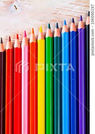 Multicolored pencils on wooden background, nobody 106080197