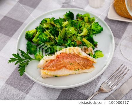 Appetising roasted rockfish fillet with seared broccoli 106080317
