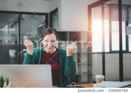 Young woman happy and excited expressing winning gesture. Successful and celebrating victory, triumphant. 106080760