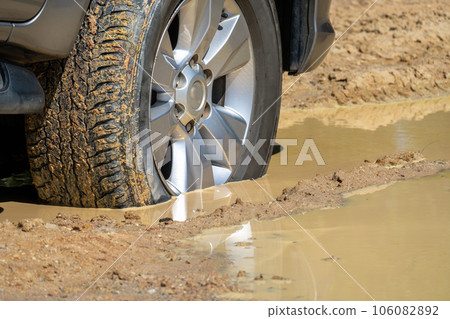 Suv 4wd car rides through muddy road Suv 4wd car rides through muddy road 106082892