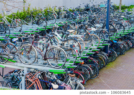 Large public bicycles parking. Old colorful bicycles in a parking lot. Netherlands, Germany. 106083645