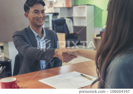 Team Business Partners shaking hands together to Greeting Start up small business in meeting room. Shakehand teamwork partners at modern office handshake together. Business mergers and acquisitions 106084397