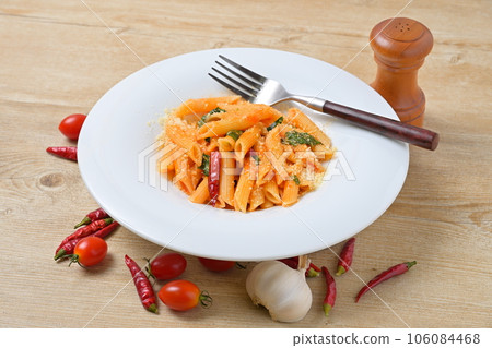 Italian food, italian penne arrabbiata, penne arrabbiata. Tomato sauce, chili peppers and grated cheese. 106084468