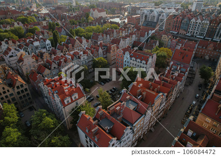 Beautiful panoramic architecture of old town in Gdansk, Poland at sunrise. Aerial view drone pov. Landscape cityscape City from Above. Small vintage historical buildings Europe Tourist Attractions Beautiful panoramic architecture of old town in Gdansk, Poland at sunrise. Aerial view drone pov. Landscape cityscape City from Above. Small vintage historical buildings Europe Tourist Attractions 106084472