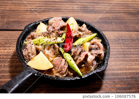Skillet gizzard ajillo on a wooden table 106087576
