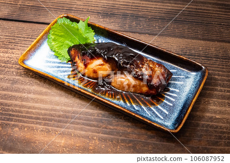 Yellowtail teriyaki served on a rectangular plate Yellowtail teriyaki served on a rectangular plate 106087952